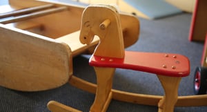 A rocking horse with a red seat