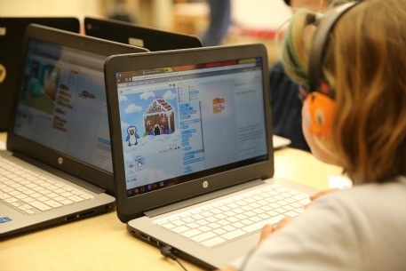 Student using a laptop in a classroom at Whitby School